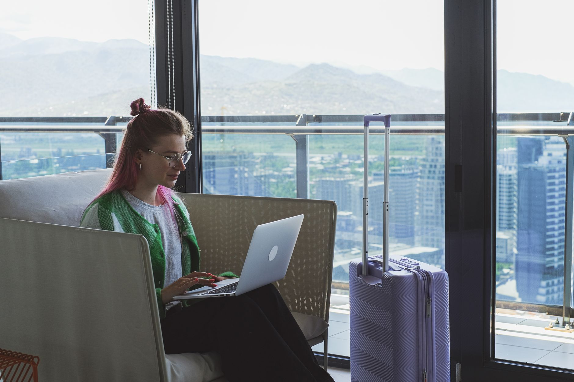Travel writer reviewing notes beside scenic window
